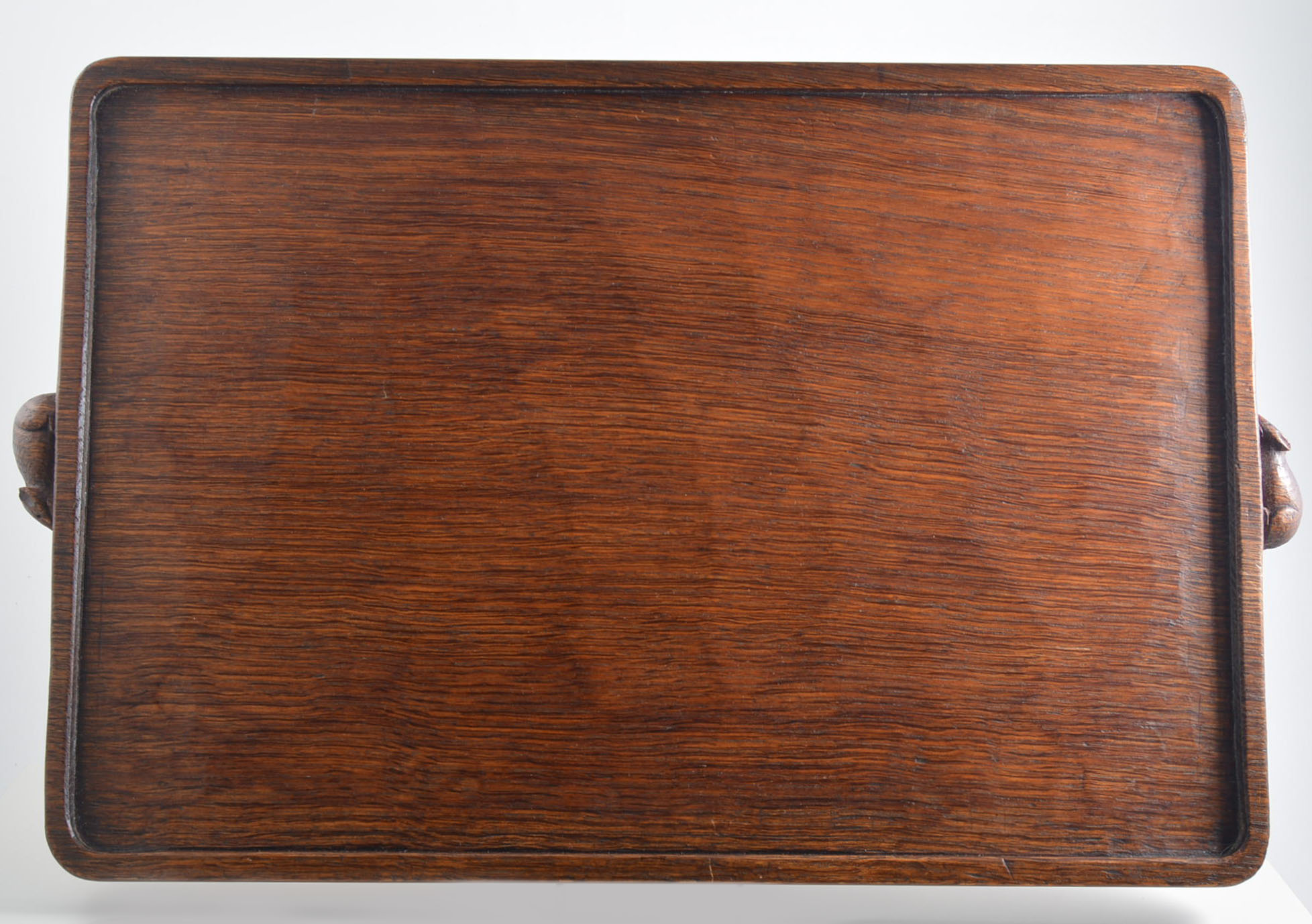 Robert 'Mouseman' Thompson of Kilburn, an Arts & Crafts dark oak tea tray, rectangular form,