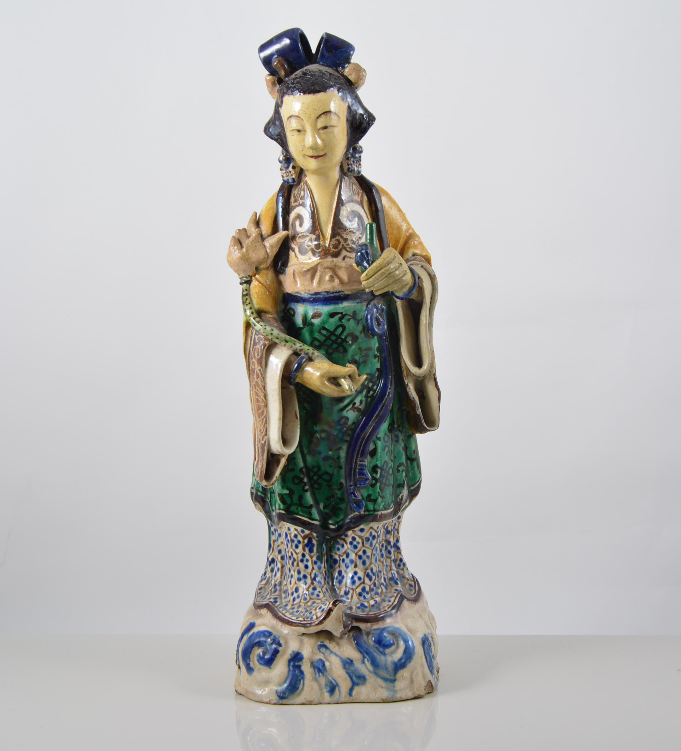 Chinese pottery figure of a woman with a serpent and bottle, decorated in lead colours, 37cms.