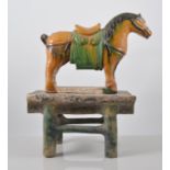 Tang style lead glazed model of a horse, decorated predominantly in ochre and green, 20cms.