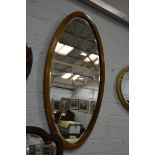 Edwardian oval wall mirror, mahogany frame with boxwood stringing, bevelled plate, 87 x 46cms.