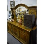 Edwardian oak sideboard, mirrored-back with arched moulded cornice,