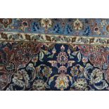 Persian pattern small carpet, central medallion surrounded by floral motifs on a blue ground,