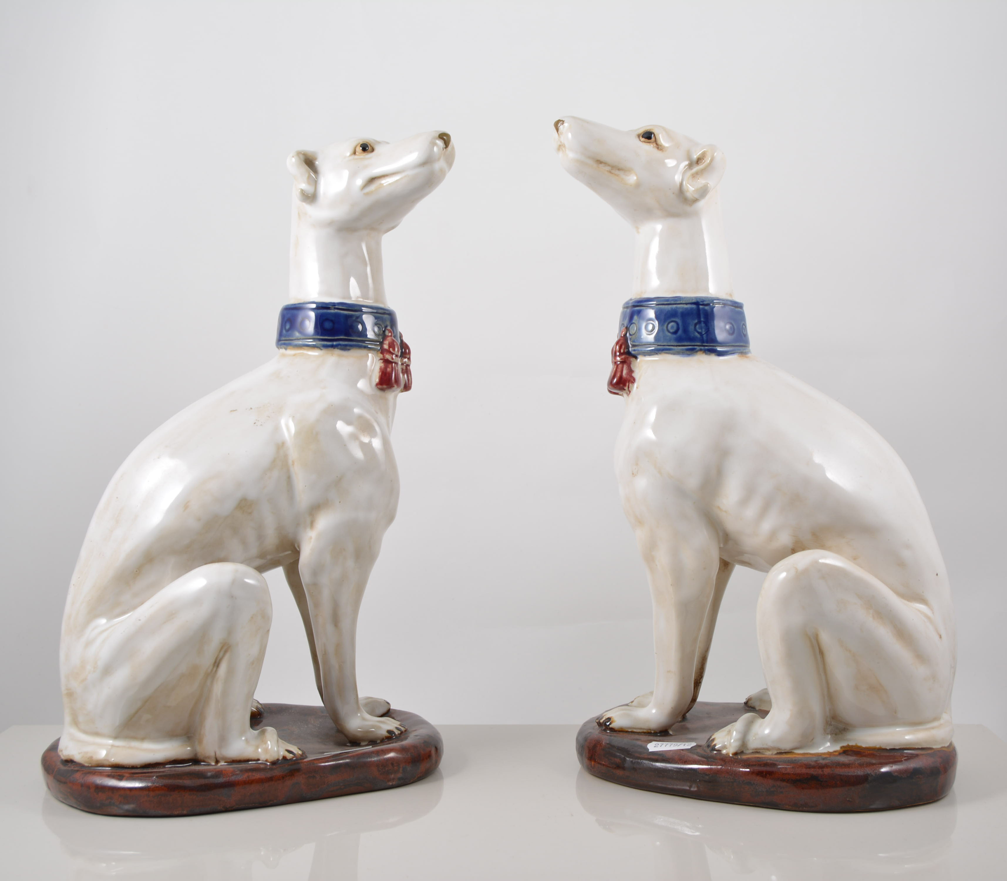 Pair of Majolica style models, of seated hounds, perhaps Italian, 37cms.