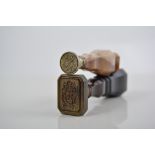 Brass seal, with a tapering agate handle, monogram intaglio, 7.5cms and another hardstone seal, (2).