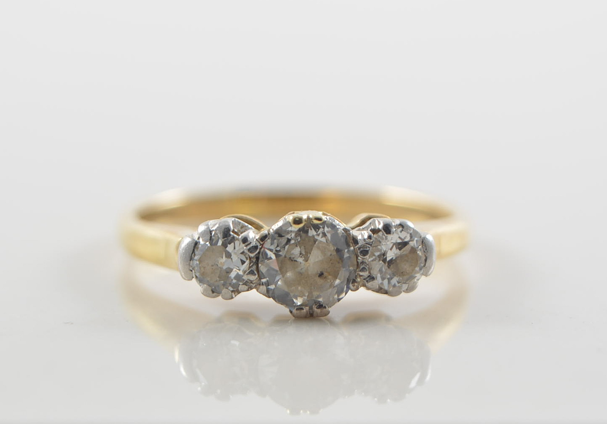 Traditional three stone diamond ring,