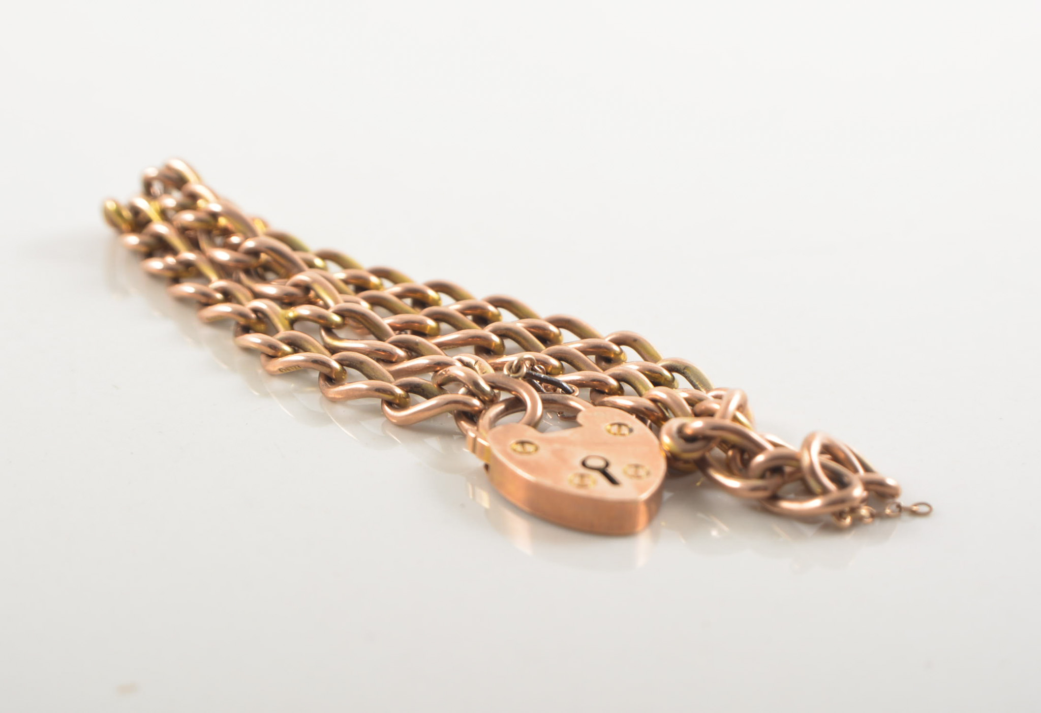 9 carat rose gold bracelet, two rows of solid long curb links (formed from an albert),