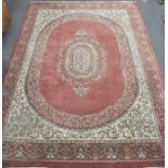 Modern Persian pattern carpet, floral pattern on a pink ground, 366cm x 272cm.