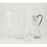 A cut glass decanter and stopper, and other decanters.