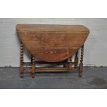 Oak gateleg dining table, oval top with two fall leaves, barley twist supports to the top,