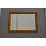 Modern wall mirror, gilt leaf and flower border frame, rectangular bevelled plate, height 65cm,