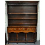 Joined oak dresser, moulded cornice, open fretted frieze, three fixed shelves to the back,