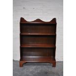 Mahogany open waterfall bookcase, three fixed shelves, bracket feet, width 77cm, depth 26cm,