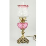 Victorian style table lamp, ruby tinted and moulded shade and reservoir with chimney,
