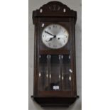 1940's oak wall clock, circular silver dial, part glazed door, length 79cm.