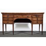 A George III mahogany bow front sideboard, the top with boxwood stringing and mahogany crossbanding,