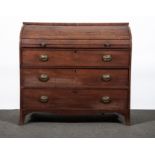 A George IV mahogany tambour front bureau, enclosing a second tambour with drawers and pigeon holes,