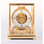 A Jaeger le Coultre Atmos clock, no. 425539, five plate glazed case, what chapter ring, 23cm.