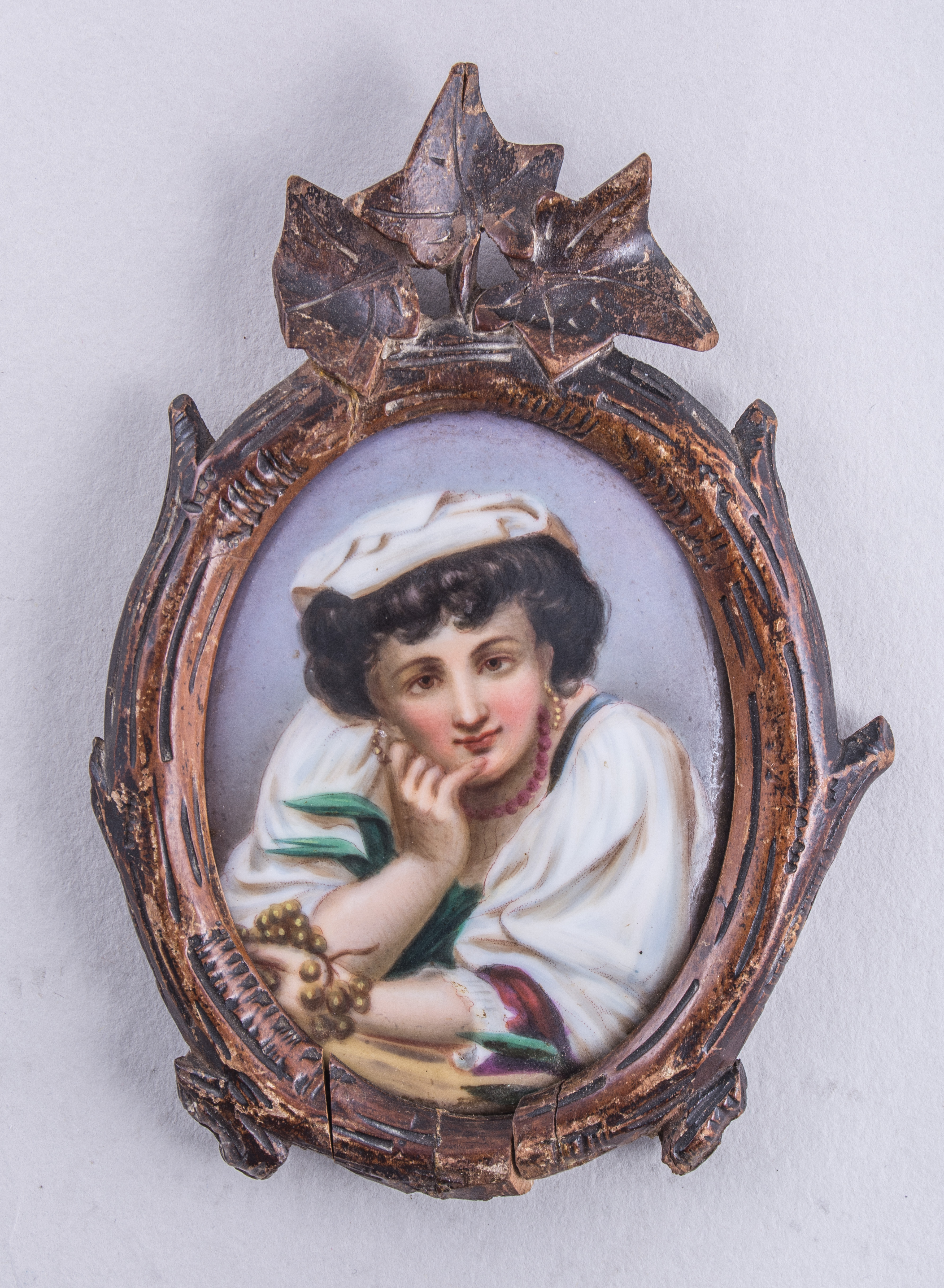 Two German porcelain oval plaques, Tyrolean man and a Neapolitan girl, over print foundations, 8.