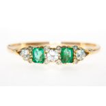 An emerald and diamond half hoop ring, emeralds (2), step cut stones, diamonds (3),