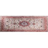 A Persian pattern rug, central floral medallion, on pale ground with stylised flowers,