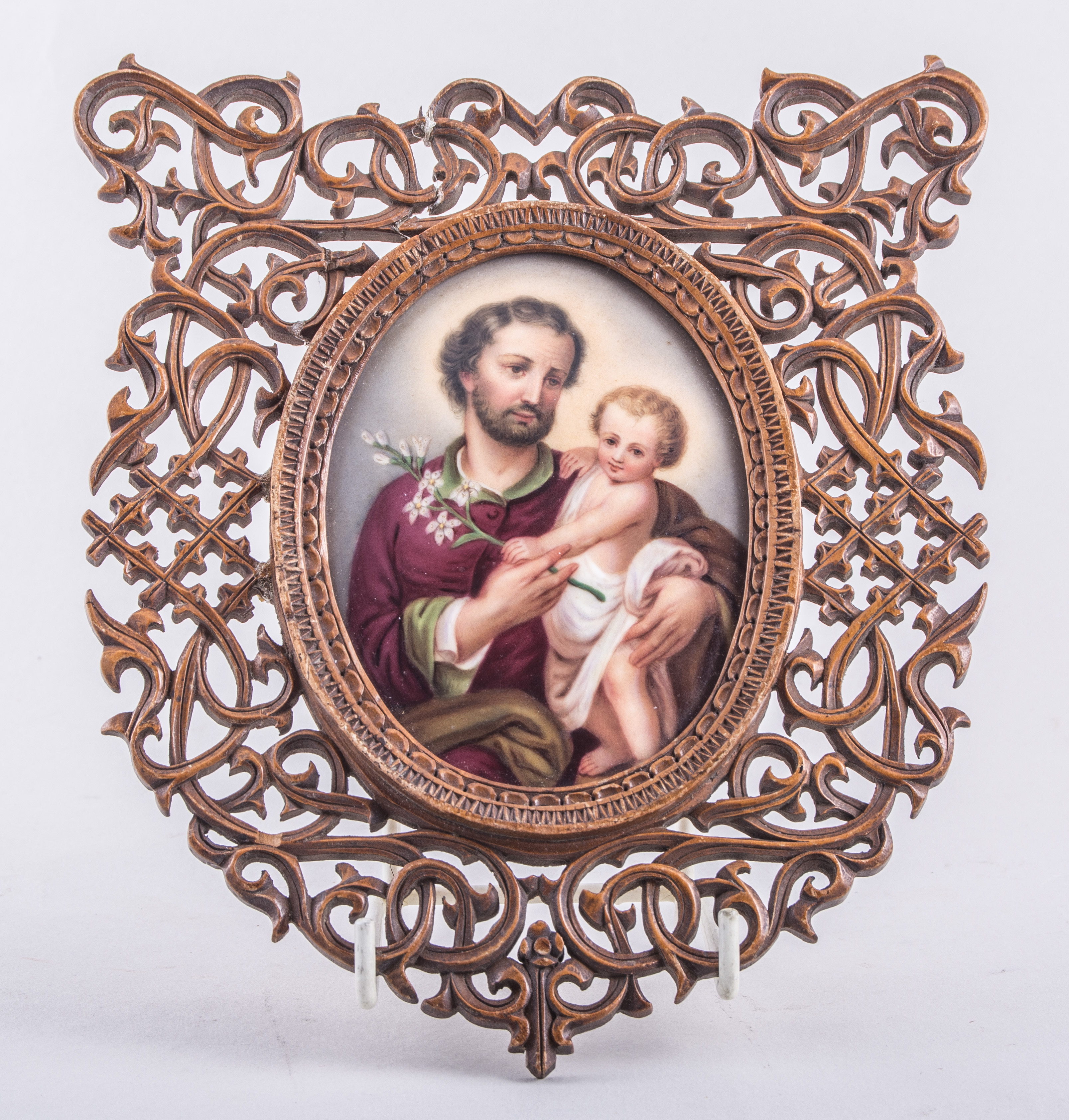 A German porcelain oval plaque, Berlin style, St Joseph and the Christ Child, 11cm x 8cm,