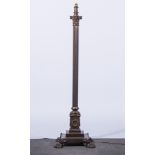 A bronzed Corinthian column standard lamp, fluted shaft, square plinth, lion paw feet,