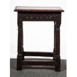 A joined oak stool in part 18th Century, rectangular top with a moulded edge, carved frieze,