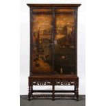 An oak and leather panelled cabinet on stand, Dutch leather panels probably adapted from a screen,