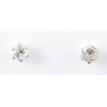 A pair of diamond solitaire earrings,