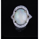 An opal and diamond dress ring, the oval cabochon cut opal, 15mm x 12mm,