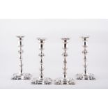 A set of four George III style silver table candlesticks, by Henry Wilkinson & Co.