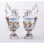 A pair of Capodimonte style ornamental ewers, 20th Century, moulded decoration with figures,