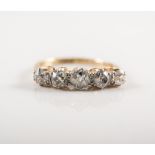 A traditional diamond five stone ring, the five old cut stones, graduating in size,