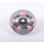 A Clichy pattern Millefiore paperweight, mid 19th Century, centered with a white rose,