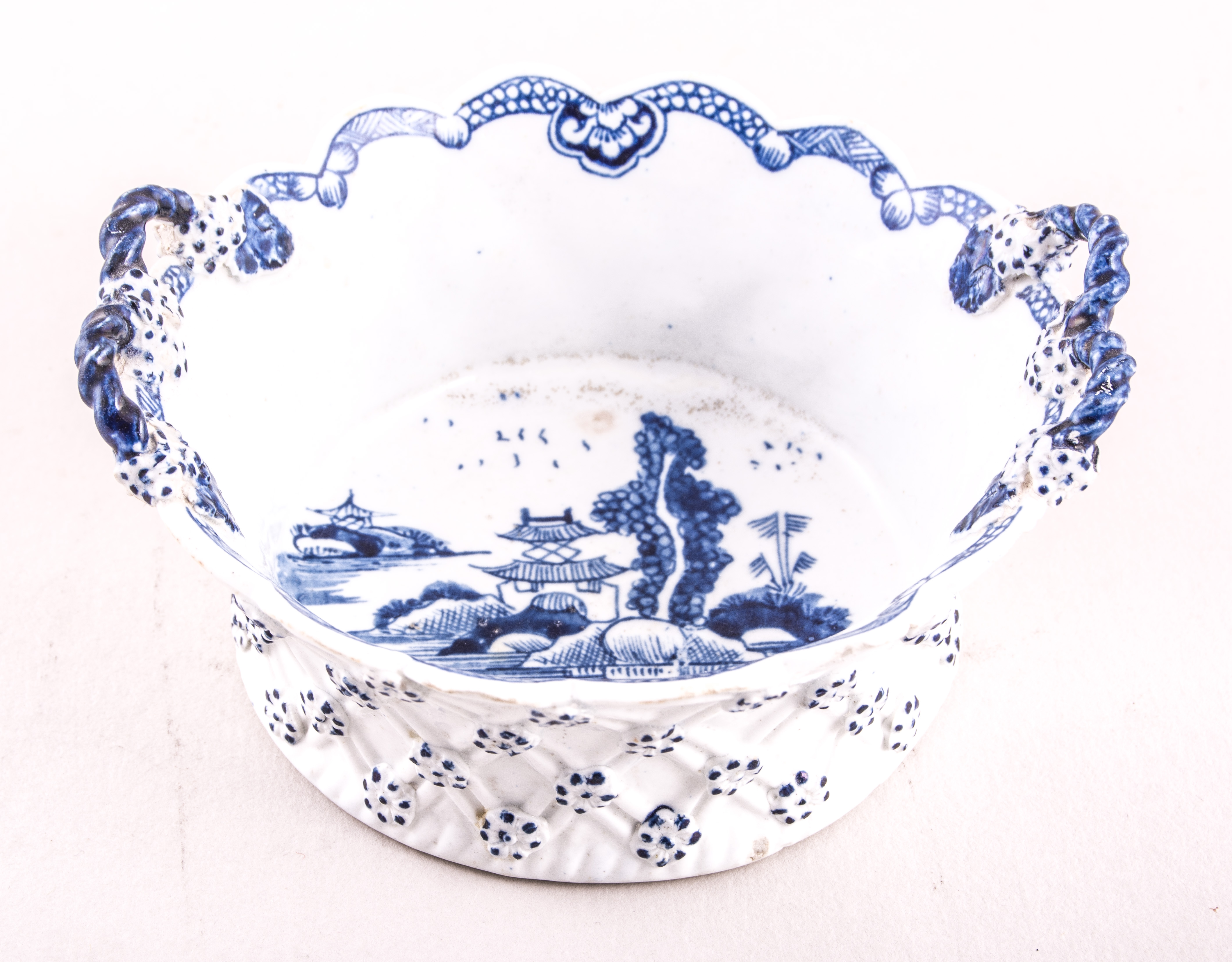 A small Lowestoft blue and white basket shaped dish, circa 1770, double loop handles,