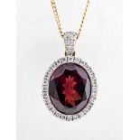 A garnet and diamond oval cluster pendant, the oval mixed cut garnet 11mm x 10mm,