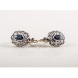 A pair of sapphire and diamond oval cluster earrings , an oval mixed cut sapphire to each earring,