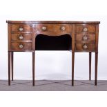 A George III style mahogany sideboard, 19th Century, serpentine front, central frieze drawer,