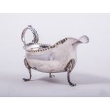 A George III silver sauce boat, by Charles Hougham, London 1778, leaf capped flying scroll handle,