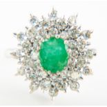 An emerald and diamond oval cluster ring,