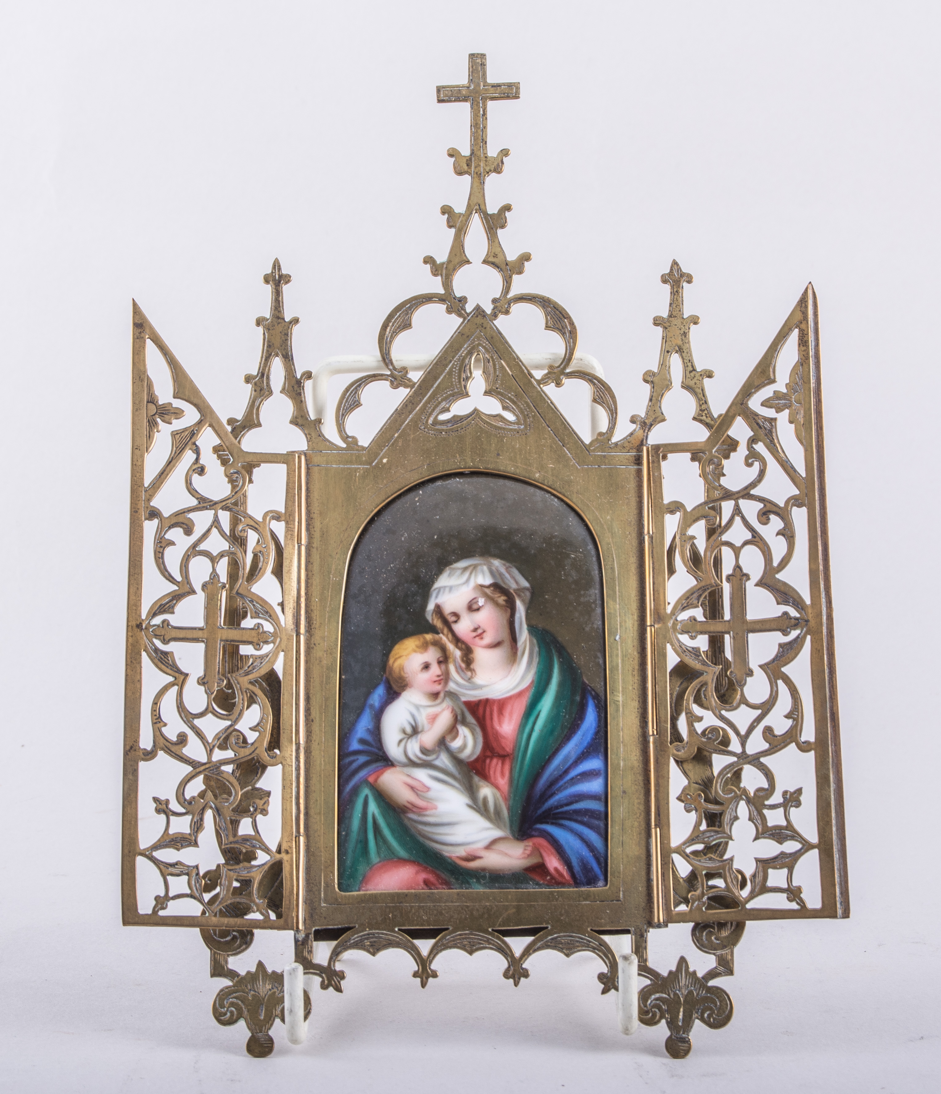 A German porcelain arched plaque, Madonna and Child, over a print foundation, 9cm x 6cm,