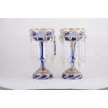 A pair of Victorian blue overlaid glass lustres, gilt painted decoration, shallow bowls,