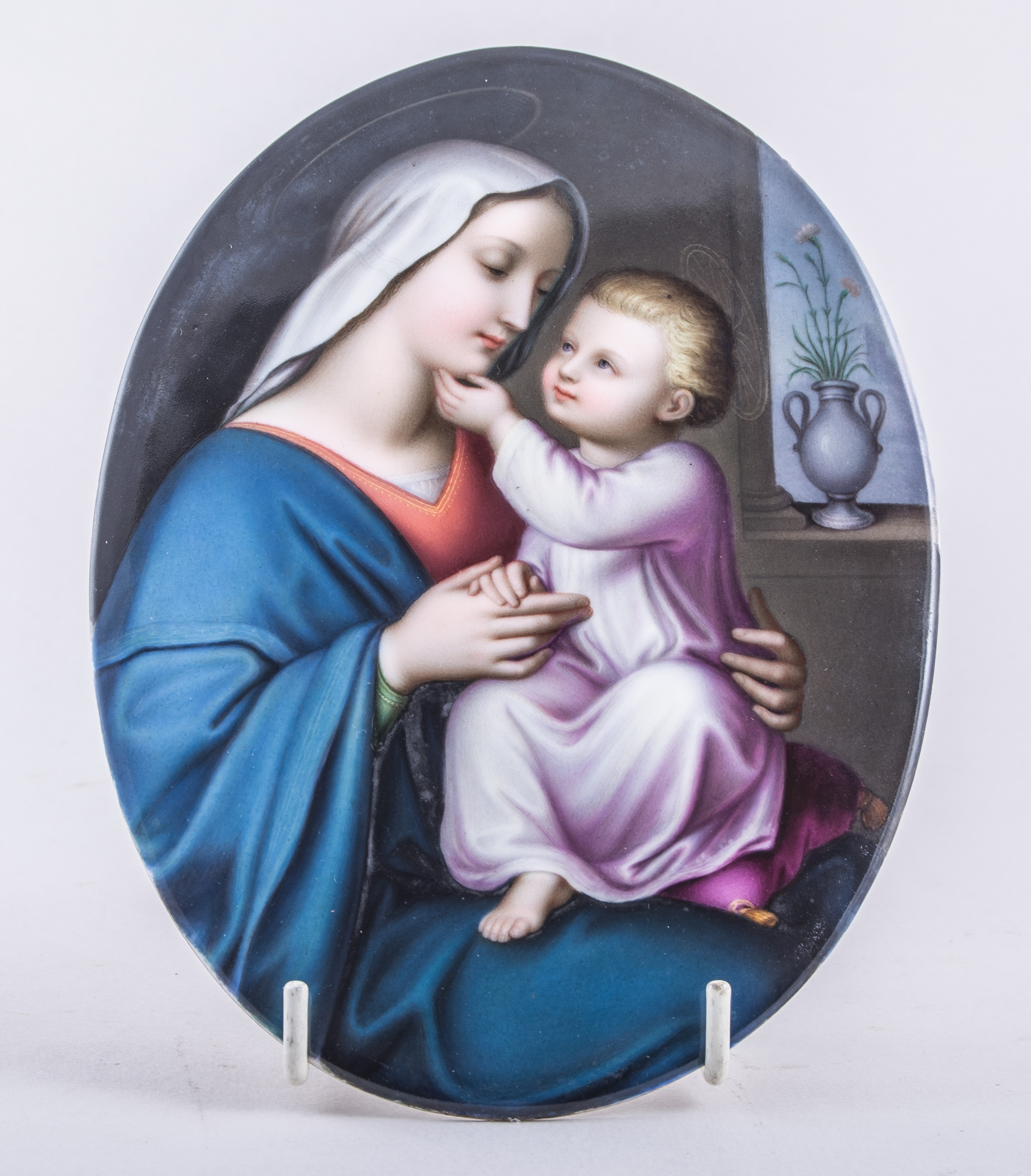 A German porcelain oval plaque, probably Berlin, a Raphaelite Madonna and Child, unframed,