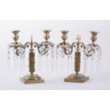 A pair of French Empire style gilt metal two light candelabra, fluted columns,