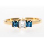 A sapphire and diamond traditional three stone ring,