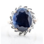 A sapphire and diamond oval cluster ring, the oval mixed cut stone, 12mm x 10mm,