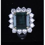 A large emerald and diamond rectangular cluster ring,