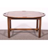 A late Georgian mahogany butlers tray, oval top with four flaps, 93cm x 66cm on a stand,