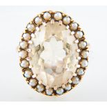 A citrine and pearl dress ring, the pale yellow oval mixed cut citrine, 20mm x 15mm,