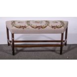 A George III mahogany window seat, gros point floral upholstery, square moulded legs, H stretchers,